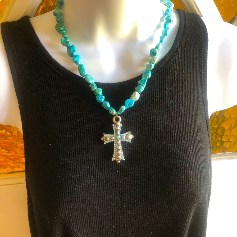 Turquoise necklace with a cross.